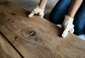 Carpenter man installing wooden floor